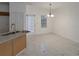Open-concept dining area featuring marble floors and a stylish chandelier at 5090 Leeshire Trce, Tucker, GA 30084