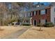 Charming townhome with a partial brick facade, complemented by mature trees and landscaping at 5090 Leeshire Trce, Tucker, GA 30084