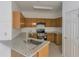 Bright kitchen features granite countertops, stainless steel appliances, and wooden cabinets at 5090 Leeshire Trce, Tucker, GA 30084