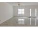 Bright and airy living room showcasing light marble flooring and ample natural light from a large window at 5090 Leeshire Trce, Tucker, GA 30084