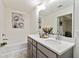 Well-lit bathroom with double sinks, quartz countertop, and a relaxing soaking tub at 6315 Princeton Ridge Dr, Lithonia, GA 30058