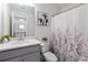 Bright bathroom featuring a modern vanity with quartz countertop and stylish floral shower curtain at 6315 Princeton Ridge Dr, Lithonia, GA 30058