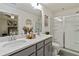 Modern bathroom featuring dual sinks, quartz countertop, and glass-enclosed shower at 6315 Princeton Ridge Dr, Lithonia, GA 30058