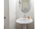 Half bathroom showcasing a pedestal sink with a chrome faucet and a round mirror at 6315 Princeton Ridge Dr, Lithonia, GA 30058