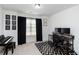 Office with a desk, piano, black and white rug, natural light, and minimalist decor at 6315 Princeton Ridge Dr, Lithonia, GA 30058