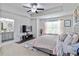 Primary bedroom with en suite bathroom, tray ceilings, and plush carpeting at 6315 Princeton Ridge Dr, Lithonia, GA 30058