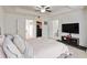 Bright bedroom featuring tray ceilings, a walk-in closet, and a modern media center at 6315 Princeton Ridge Dr, Lithonia, GA 30058