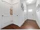 Bright hallway with hardwood floors, white doors, and modern wall decor at 6315 Princeton Ridge Dr, Lithonia, GA 30058