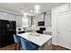 Modern kitchen featuring gray cabinets, a black refrigerator, and a center island with pendant lighting at 6315 Princeton Ridge Dr, Lithonia, GA 30058