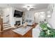 Cozy living room featuring a fireplace, hardwood floors, and neutral-toned furniture at 6315 Princeton Ridge Dr, Lithonia, GA 30058