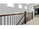 Elegant staircase featuring dark wood railing and black iron balusters, leading to the upper level at 6315 Princeton Ridge Dr, Lithonia, GA 30058