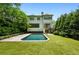 Sprawling backyard features a pool, lush lawn, mature trees, and an upper porch at 444 Rock Springs Ne Rd, Atlanta, GA 30324