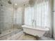 Modern bathroom features a standalone tub, glass shower, and marble tile at 444 Rock Springs Ne Rd, Atlanta, GA 30324