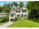 Charming two-story home featuring a manicured lawn and black shutters that add a touch of elegance to its design at 444 Rock Springs Ne Rd, Atlanta, GA 30324