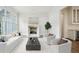 Bright, airy living room with fireplace, large windows, and stylish white sofas and chairs at 444 Rock Springs Ne Rd, Atlanta, GA 30324