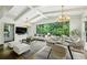 Open-concept living and dining area with vaulted ceilings, modern lighting, and expansive windows offering natural light at 444 Rock Springs Ne Rd, Atlanta, GA 30324