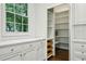 This pantry features built-in shelving, drawers, and white cabinets at 444 Rock Springs Ne Rd, Atlanta, GA 30324