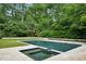 Backyard pool with hot tub surrounded by lush greenery and a stone patio at 444 Rock Springs Ne Rd, Atlanta, GA 30324