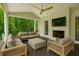 Covered porch features a fireplace, mounted TV, and comfortable outdoor seating at 444 Rock Springs Ne Rd, Atlanta, GA 30324