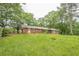 Expansive backyard showcasing a brick home and lush greenery at 4935 Golden Sw Cir, Mableton, GA 30126