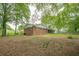 Spacious backyard with lush trees and partial view of the ranch-style house at 4935 Golden Sw Cir, Mableton, GA 30126