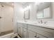 Modern bathroom featuring double sinks, quartz counters and tiled shower at 4935 Golden Sw Cir, Mableton, GA 30126