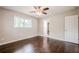 This bedroom has hardwood floors and a ceiling fan at 4935 Golden Sw Cir, Mableton, GA 30126