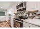 Up-close of the kitchen with stainless steel appliances and tiled backsplash at 4935 Golden Sw Cir, Mableton, GA 30126
