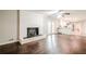 Open living space features a white brick fireplace, ceiling fan and hardwood flooring at 4935 Golden Sw Cir, Mableton, GA 30126
