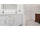 Modern bathroom features a dual sink vanity, illuminated mirror and a walk in closet at 502 Brighton Pt, Atlanta, GA 30328