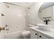 Bright bathroom featuring a tub-shower combo, white subway tile, and a modern vessel sink with a round mirror at 502 Brighton Pt, Atlanta, GA 30328