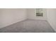 Bright bedroom with a window and neutral carpet flooring at 502 Brighton Pt, Atlanta, GA 30328