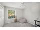 Bright bedroom features plush carpet, ceiling fan, and natural light from the exterior window at 502 Brighton Pt, Atlanta, GA 30328