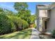 Inviting home exterior with stone accents, sidewalk, grassy area and lush landscaping at 502 Brighton Pt, Atlanta, GA 30328