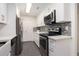 Modern kitchen with stainless steel appliances, white cabinets, and subway tile backsplash at 502 Brighton Pt, Atlanta, GA 30328
