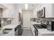 Well-lit kitchen featuring stainless appliances, white cabinets, and modern fixtures at 502 Brighton Pt, Atlanta, GA 30328