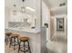 Modern kitchen with white cabinetry, mosaic backsplash, and breakfast bar seating at 502 Brighton Pt, Atlanta, GA 30328