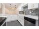 Modern kitchen featuring white cabinetry, granite countertops, and stainless steel appliances and farm sink at 502 Brighton Pt, Atlanta, GA 30328