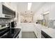 Contemporary white kitchen with stainless steel appliances and stylish tile backsplash at 502 Brighton Pt, Atlanta, GA 30328