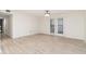 Spacious room with laminate flooring, ceiling fan, and patio doors to the exterior at 502 Brighton Pt, Atlanta, GA 30328