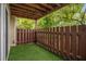 Cozy outdoor patio area with artificial grass, privacy fence, and wood ceiling at 502 Brighton Pt, Atlanta, GA 30328
