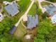 Aerial view of a landscaped property with a circular driveway, backyard patio, pool, and additional RV storage at 7511 Biltmore Ln, Douglasville, GA 30135