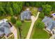 Aerial view of a spacious home with a manicured lawn, mature trees, long drive, and inviting outdoor spaces at 7511 Biltmore Ln, Douglasville, GA 30135