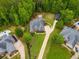 Stunning aerial view of a home surrounded by lush greenery with a long driveway and well-maintained lawn at 7511 Biltmore Ln, Douglasville, GA 30135