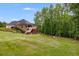 Large backyard with a deck and patio offers ample space for outdoor activities and enjoying the scenic surroundings at 7511 Biltmore Ln, Douglasville, GA 30135