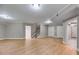Spacious finished basement with wood-look floors, recessed lighting, and staircase at 7511 Biltmore Ln, Douglasville, GA 30135