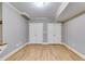 Spacious basement featuring two closets with shelving and new hardwood flooring at 7511 Biltmore Ln, Douglasville, GA 30135