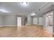 Open basement living space with hardwood flooring and stairs to upper level at 7511 Biltmore Ln, Douglasville, GA 30135