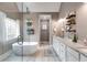 Modern bathroom with sleek free standing tub, glass shower, granite counters, and decorative window at 7511 Biltmore Ln, Douglasville, GA 30135