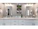Bathroom featuring double vanity with granite countertops and industrial shelves for storage at 7511 Biltmore Ln, Douglasville, GA 30135